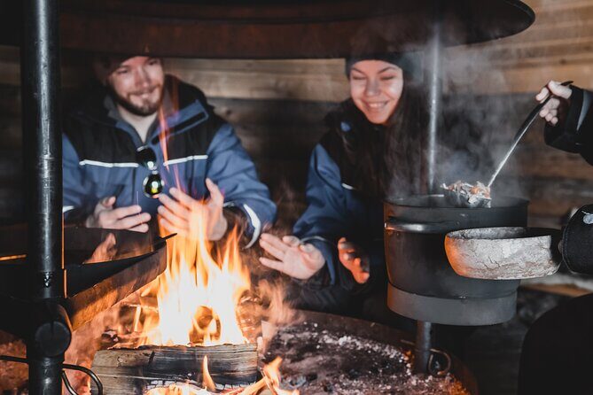 Lappish Lunch Break -Snowmobiling, ice fishing and tasty food - Snowmobiling through Finland’s frozen rivers and open winter terrain